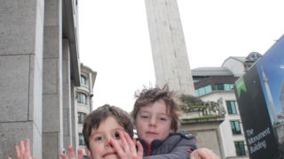 two boys review the monument to the great fire of london