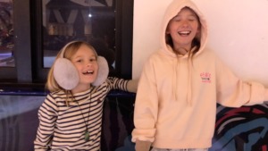 Two children happy as ever a the ice rink in Queensway