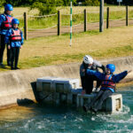 Family entering the rapids at a white water centre