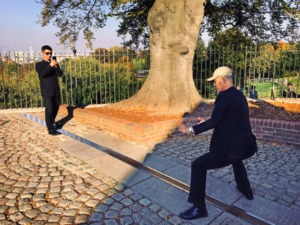 a tourist straddles the prime meridian line at Greenwich - 50 Things for Teens To do in London Kidrated