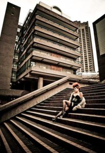 Female punk sitting on the steps of the Barbican, London