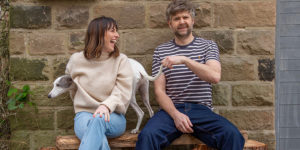 Helen Rutter and rob rouse laughing together on a bench