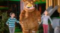 a boy and a girl holding hands with the gruffly