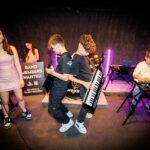 2 boys playing keytars at WeJam