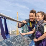 Dad and daughter at the top of Up at the O2 on a family climb