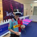 boy wearing VR headset holding controllers at VRXtra Kingston