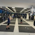 Kids playing on mats wearing VR headsets at VRXtra