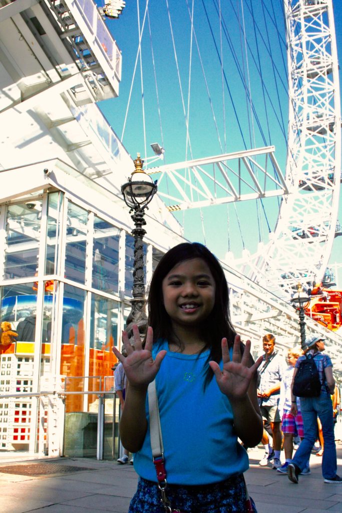 girl reviews the london eye ferris wheel