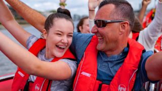 Dad and daughter enjoying their thames rocket boat tour