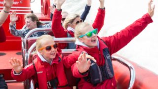two happy kids on the thames rocket boat tour