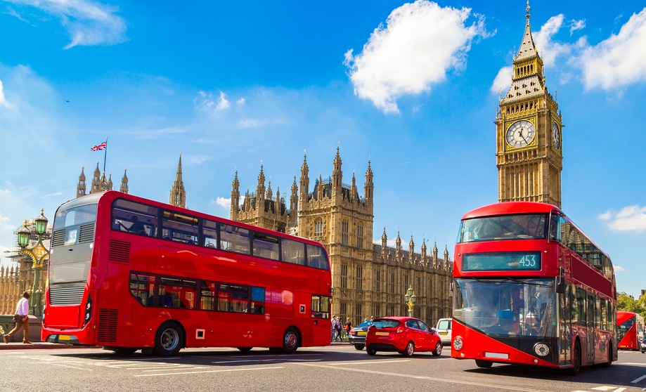 Two iconic red buses on Westminster Bridge