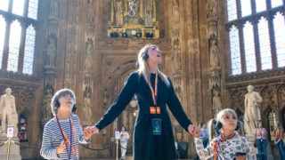 An adult and 2 children inside an amazing room at the Palace of WEstminster