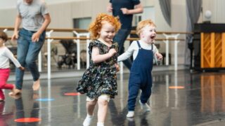 2 small children running around in a Rambert dance class