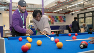Kid and adult playing pool at WEST Youth Zone