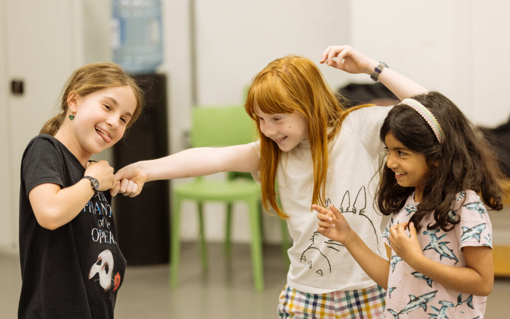 kids stage fighting in an acting workshop
