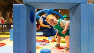 child looking through blocks